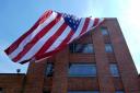 A giant American flag is unfurled on Lisner Hall on the campus of George Washington University in Washington (Susan Walsh/AP)