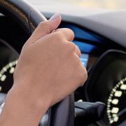 A generic photo of a person behind the steering wheel