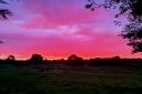 Fiery sunrise over the fields at Belton farm by Callum Beddows
