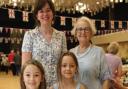 Professor Norma Raynes, is pictured with her twingranddaughters Jorgina and Sofia Varle-Raynes and then Whitchurch market manager Zoe Dean. .