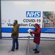 People queuing to receive their COVID-19 vaccinations and booster injections at a vaccination site, as the Government accelerates the Covid booster programme to help slow down the spread of the new Omicron variant (PA)