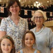 Professor Norma Raynes, is pictured with her twingranddaughters Jorgina and Sofia Varle-Raynes and then Whitchurch market manager Zoe Dean. .