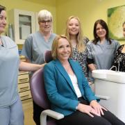 Helen Morgan MP (seated) with staff from Green End Dentists in Whitchurch.