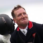 Oliver Townend celebrates on Swallow Springs during the Dressage on day one of the 2023 Defender Burghley Horse Trials in Stamford, Lincolnshire.