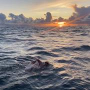 Will Smith swims towards the sunrise over France during his successful challenge.