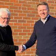 Halls managing director Jon Quinn (left) with David Owen following the signing of the deal to acquire Shenton Owen Planning and  Design.