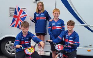 Eddie and Archie Smallman on bikes; Alex Hemmings (middle) and Sophie Kynaston (back holding flag).