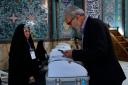 An Iranian man votes for the parliamentary runoff elections at a polling station in Tehran, Iran (Vahid Salemi/AP)