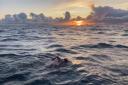 Will Smith swims towards the sunrise over France during his successful challenge.