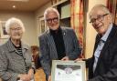 Whitchurch Rotary president Graham King (centre) presents the club’s tribute to Roly Wyatt and his wife, Kath.