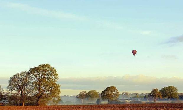 Whitchurch Herald: A hot air balloon above Prees. Picture by Paul Cheshire.