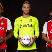Jamie Reckford, Rob Lainton and Jordan Davies in Wrexham AFC's new TikTok-sponsored home shirt
