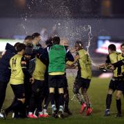 Marine players celebrate their win after extra time of the Emirates FA Cup second round match at Rossett Park, Crosby..