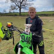Craig Lear-Jones with his motocross bike and his beloved dog.