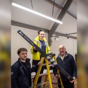 Chris Smith (right) lends a hand to Lauren Griffiths (on the ladder) and Jayden Ozturk from Barlows Electrical.