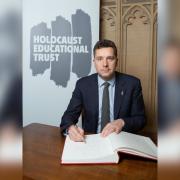 Edward Timpson CBE signing the Holocaust Education Trust Book of Commitment.