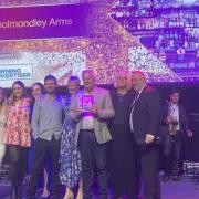 The owners and staff of The Cholmondeley Arms collect their Best Pub award.