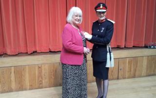 Pauline Dee (left), pictured receiving her British Empire Medal from Lady Anna Turner, has spoken up on ca rparking charges.
